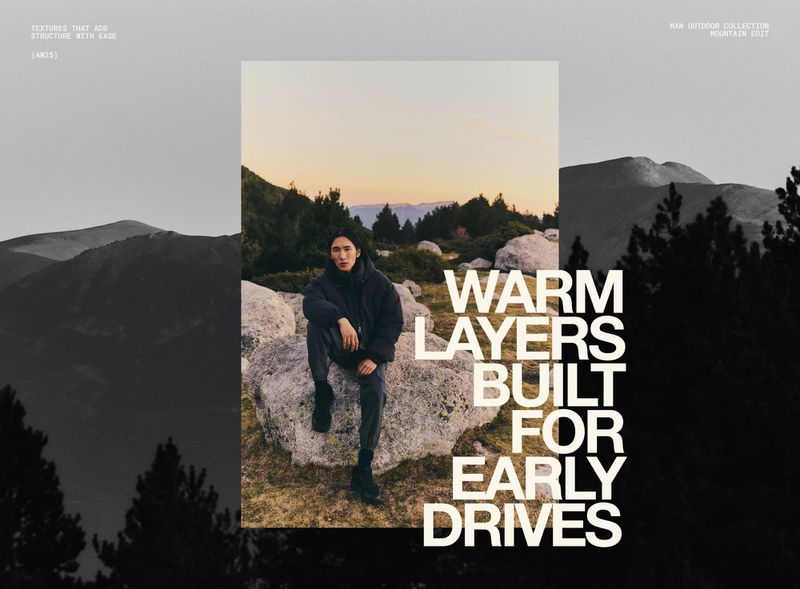 An adult male sits on a rock in an outdoor setting with a mountain backdrop, styled in a dark jacket and pants, under muted sunset lighting.
