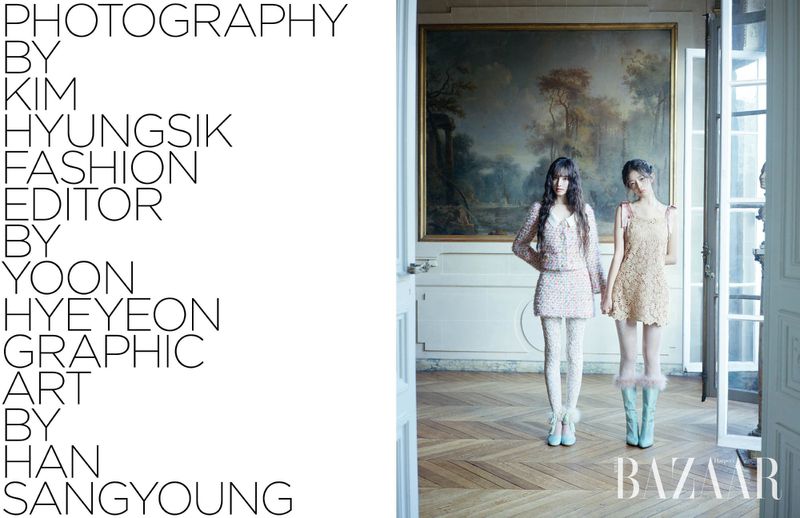 Two women stand in vintage-inspired dresses inside a home with parquet floors, a classic painting, and white trim, in a fashion editorial.