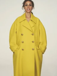 Model Adwoa Aboah wearing black tailored jacket and structured earrings in black and white British Vogue fashion editorial portrait