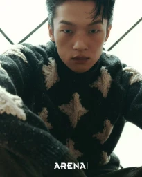 Model Jiaxuan Yang wearing a patterned black knit sweater in a portrait for Arena Homme+ Korea.
