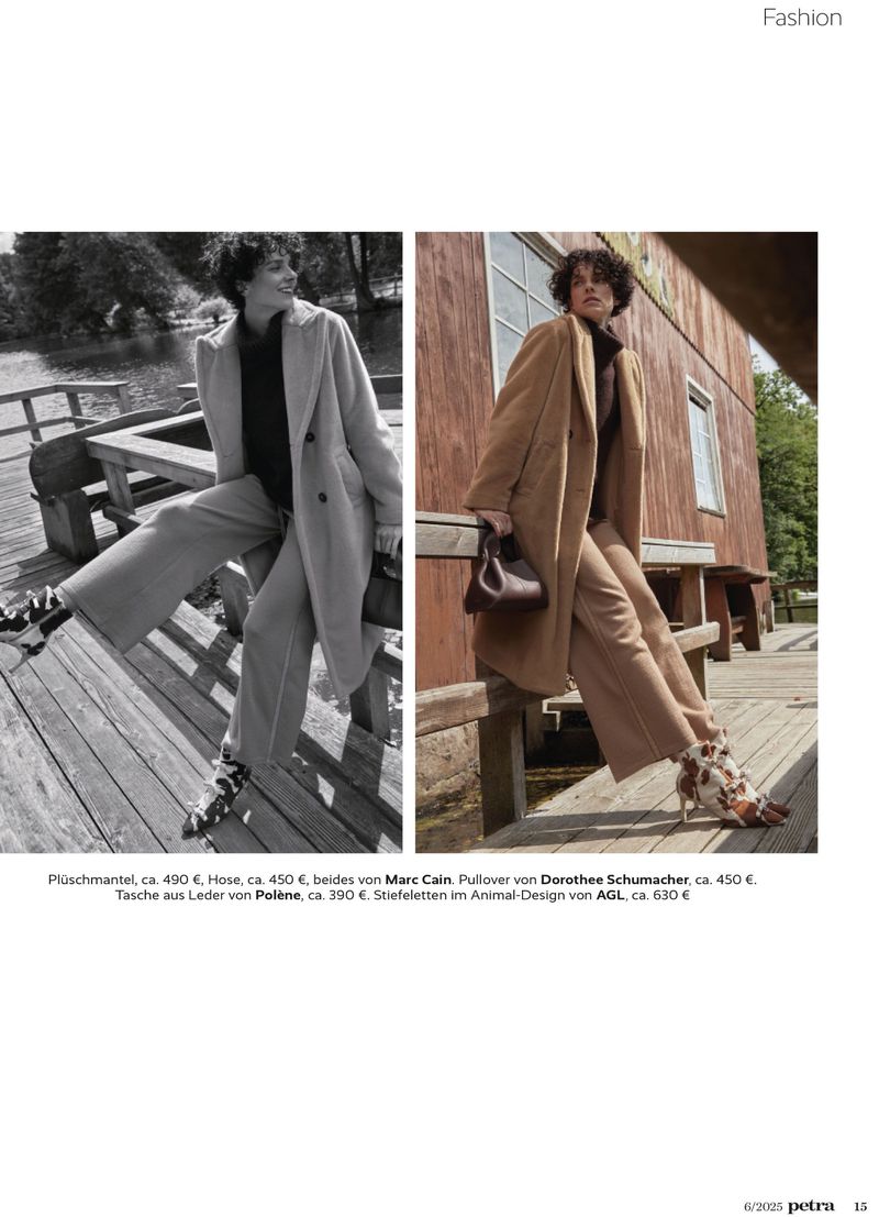 Editorial fashion shot: a woman in a tan coat and trousers poses next to a woman in grey, showcasing fall styles near a lake.