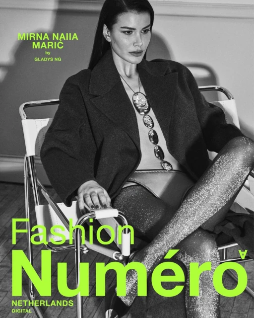 Black and white fashion magazine cover featuring a model in coat and sparkling tights sitting in a chair, bright neon text overlay.