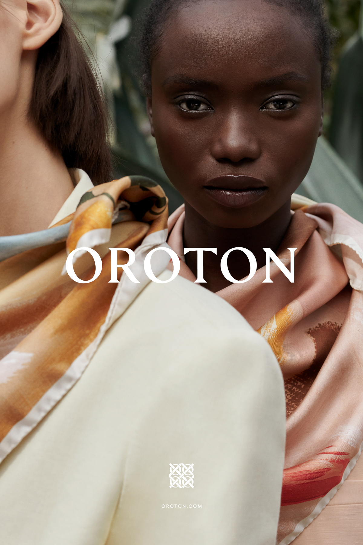 Close-up portrait of two female models wearing silk patterned scarves and neutral apparel for Oroton by Justin Woo.