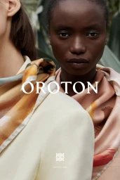 Close-up portrait of two female models wearing silk patterned scarves and neutral apparel for Oroton by Justin Woo.