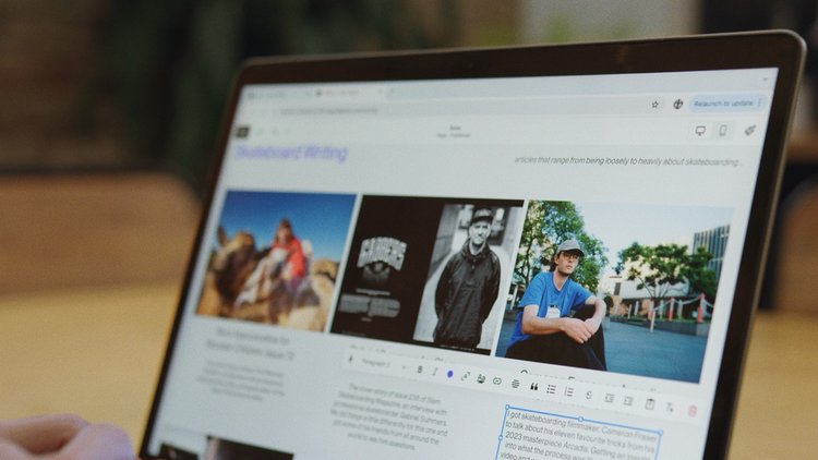 Laptop screen displays a blog with skateboarding images. The screen shows articles and text related to skateboarding content.
