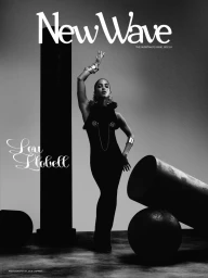 Model wearing a dark sleeveless gown posing amidst abstract pillars and geometric props in monochrome