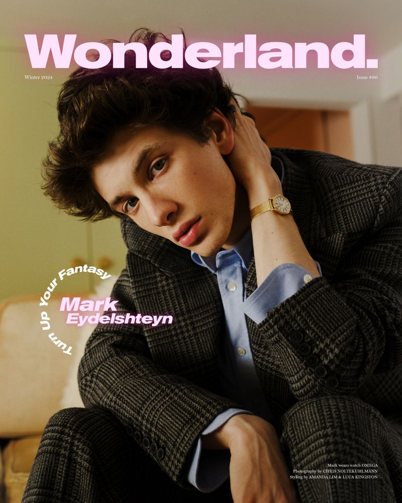 Portrait of a young man wearing a plaid suit, styled with a light blue shirt and gold watch for a Wonderland magazine cover.