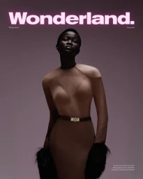 Model Anyiel Majok wearing a beige dress with a dark belt against a muted purple studio background for Wonderland Magazine