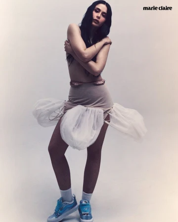 Lupita Villalobos wearing a beige skirt with white tulle puffs and blue sneakers in an editorial portrait for Marie Claire Mexico.