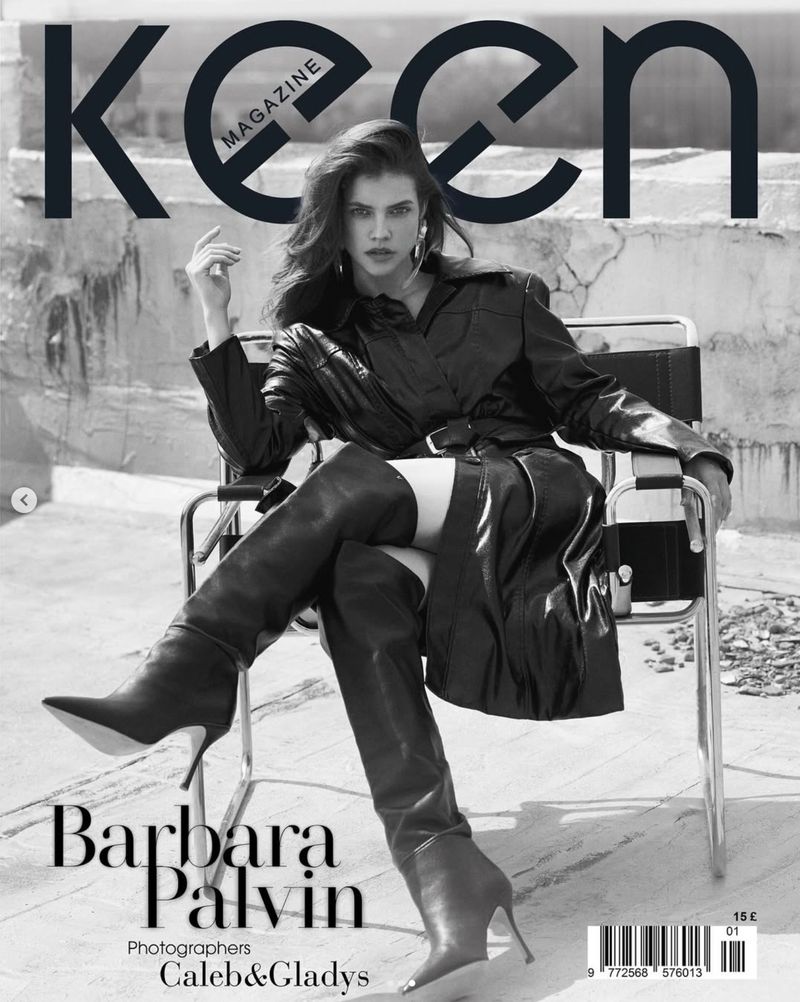 Magazine cover featuring Barbara Palvin in a black leather outfit and heeled boots sitting in a chair against a concrete background.