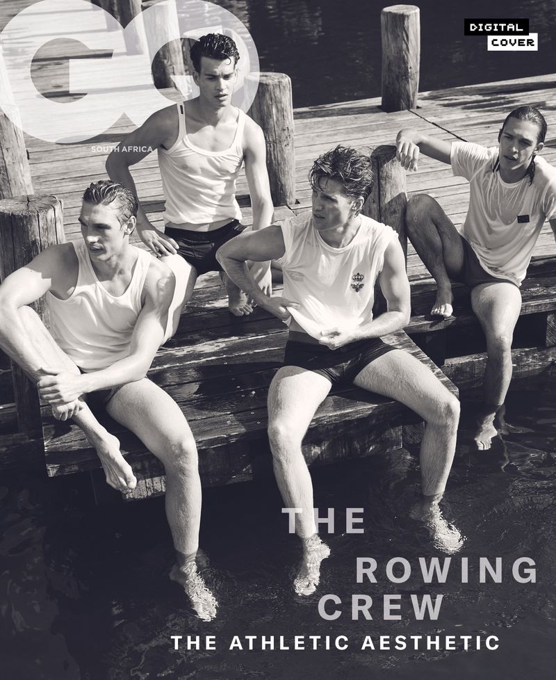 Black and white magazine cover features four young adult males wearing swim trunks sitting on a wooden pier over water, posing for a photo.