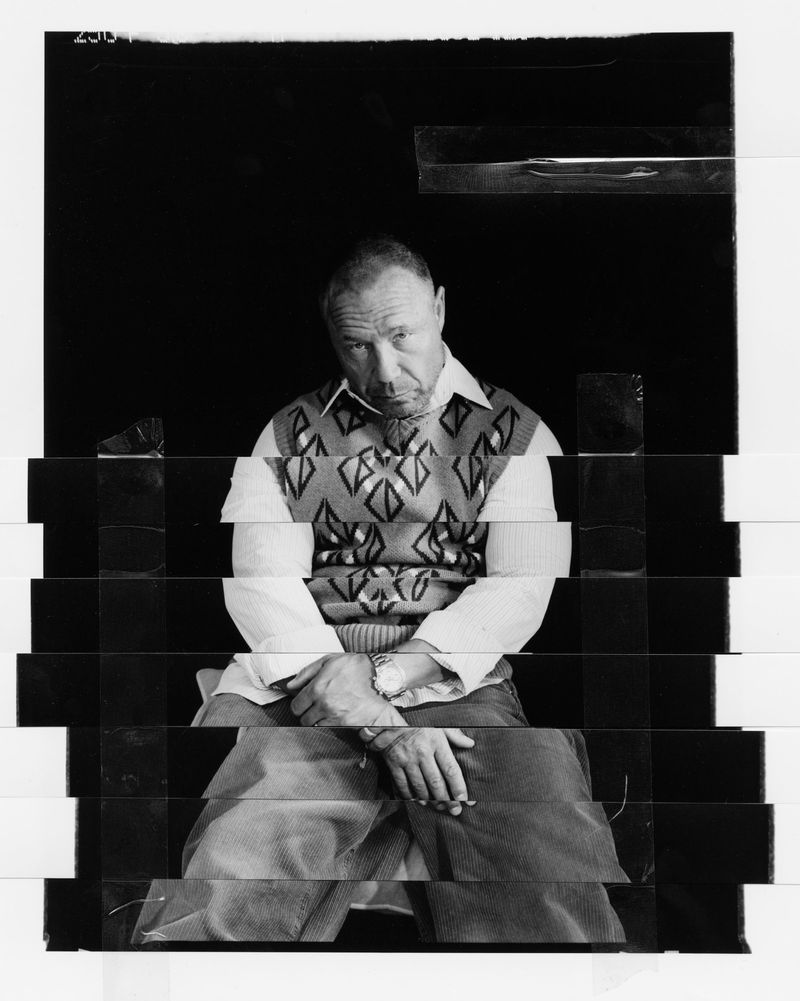 Black and white sliced collage portrait of actor Stephen Graham in a patterned knit vest, reconstructed with visible clear tape.