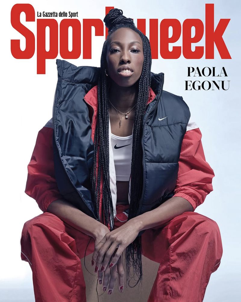 Magazine cover featuring Paola Egonu, an adult female athlete, in a navy vest and red pants, against a neutral gradient backdrop.