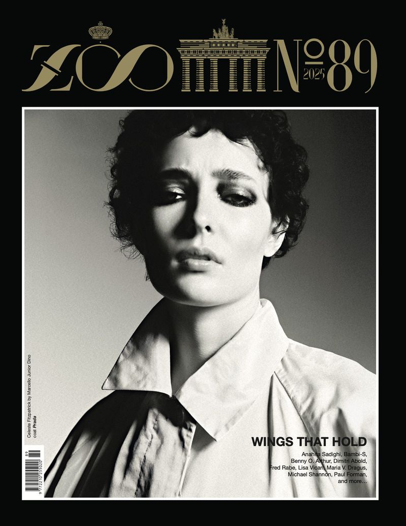 Black and white portrait of a woman with short, dark curly hair wearing a white collared shirt on the cover of ZOO Magazine.