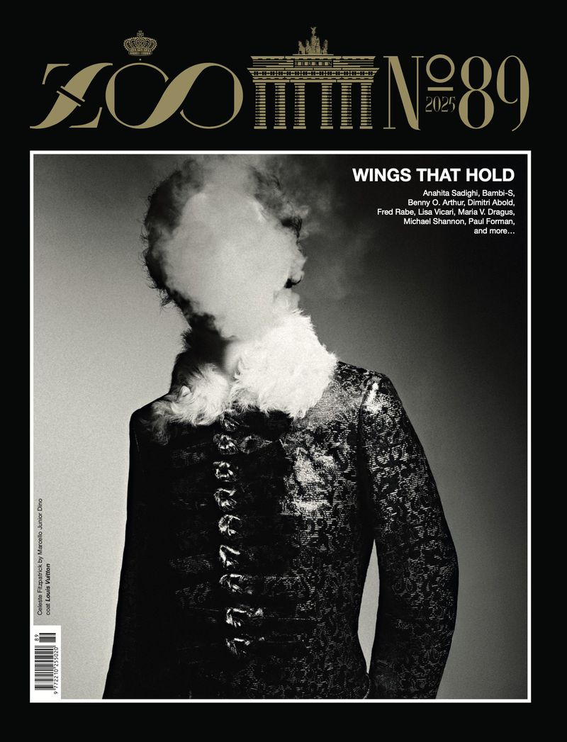 Zoo Magazine cover featuring a model in a patterned black suit with white fur collar, face obscured by smoke against a grey background.