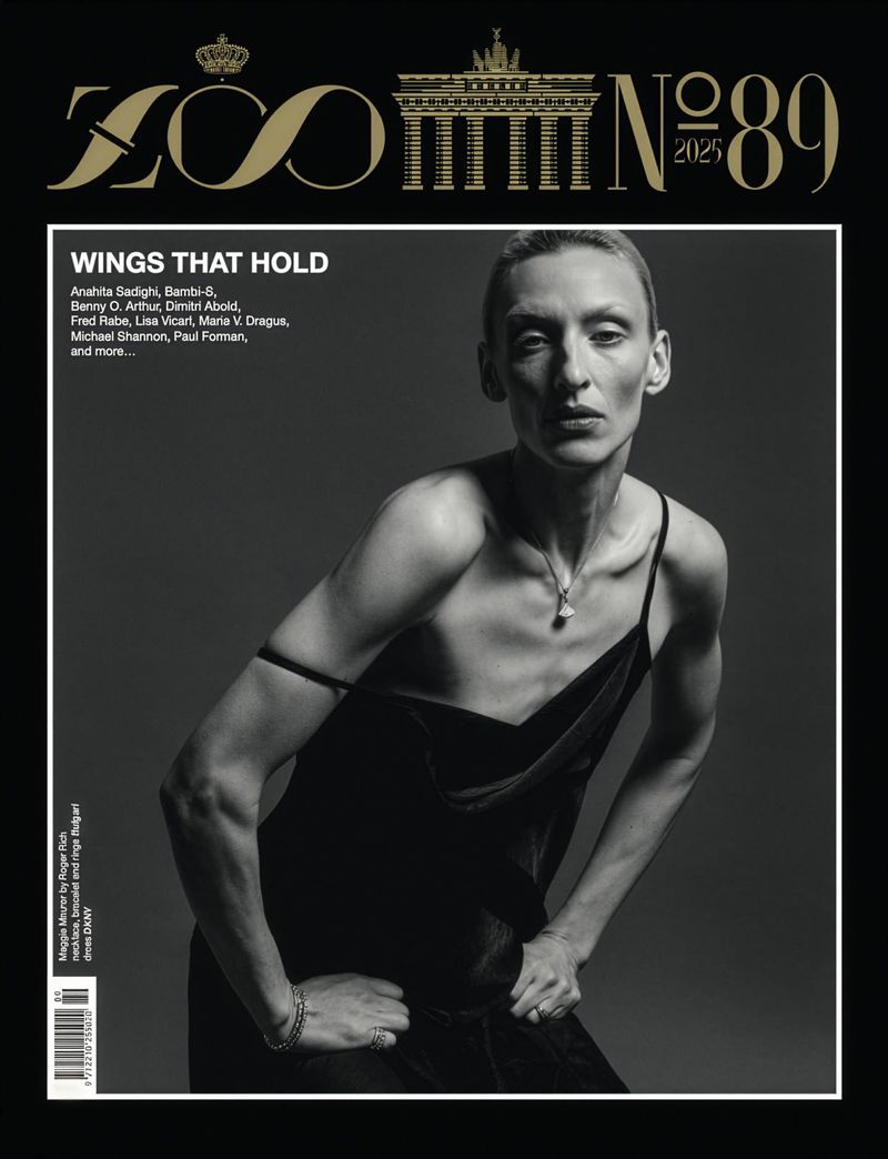 Black and white magazine cover featuring an adult woman in a black dress, gazing at the camera with a neutral expression.