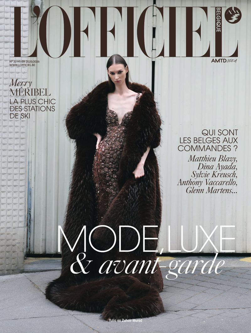 Magazine cover featuring a model in a glittering gown and fur coat, posing against a textured wall, with bold text overlay.