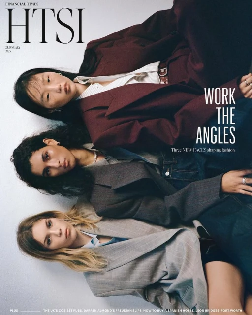 Editorial fashion shot featuring three diverse women wearing blazers, styled in an angular, eye-level studio composition.