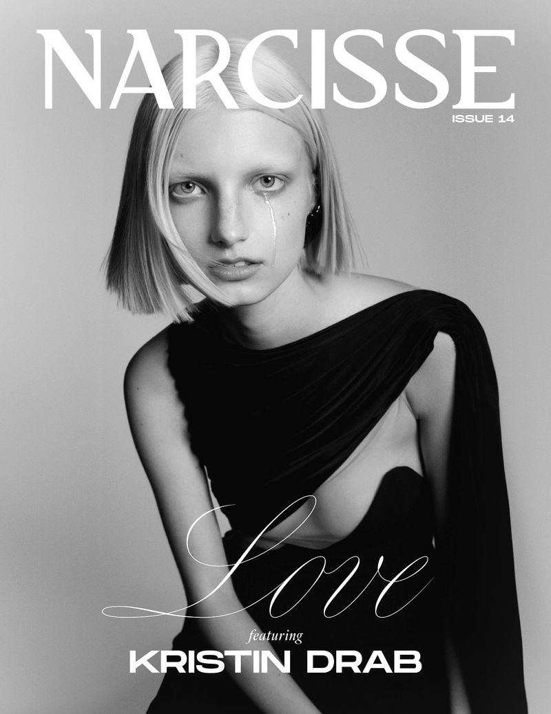 Monochrome portrait of a blonde model wearing a black dress against a grey studio backdrop for Narcisse Magazine.