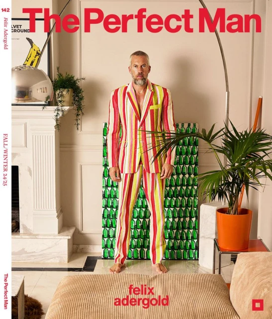 Magazine cover featuring a stylish adult male in a striped suit, set against a neutral interior with plants and design elements.