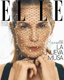 Close-up portrait of Kelly Rutherford wearing a beaded black netted veil over her face for an Elle Spain digital cover.
