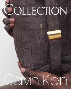 Close-up of a person holding a brown textured leather handbag with a gold clasp for Calvin Klein.