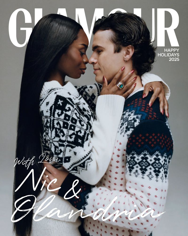 Magazine cover featuring a couple in holiday sweaters embracing in front of a gray backdrop. The cover includes the magazine's title.