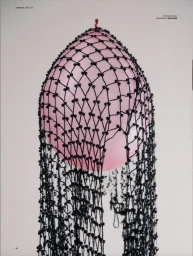 Black beaded net headpiece draped over an inflated pink balloon against a clean off-white studio background.