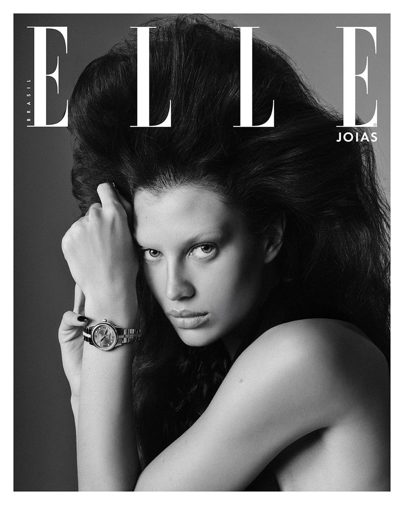 Black and white Elle magazine cover featuring a female model with voluminous dark hair and a watch.