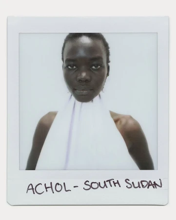 Polaroid portrait of Achol from South Sudan, showcasing a woman with dark skin in a white halter top against a light background.