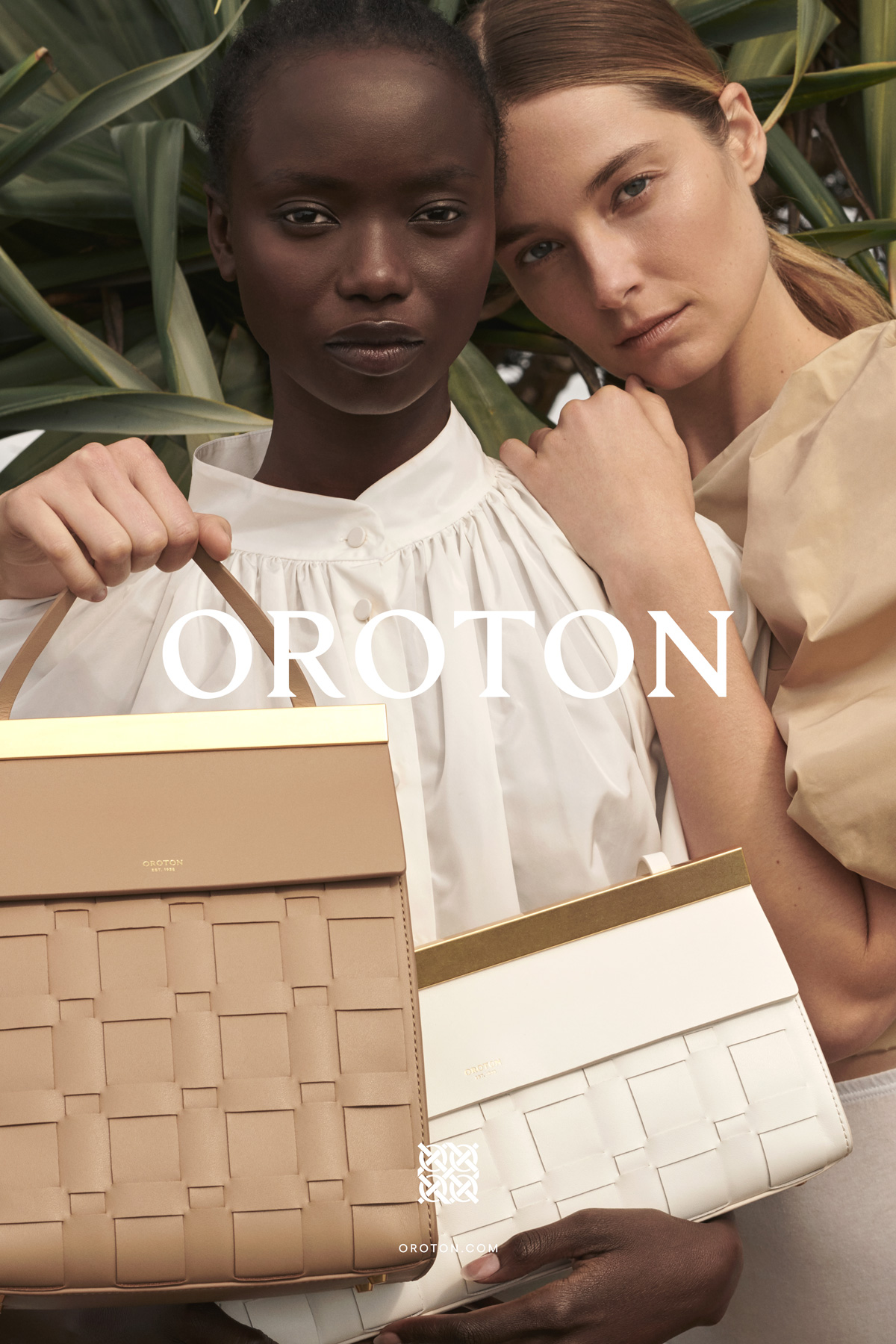 Two models pose with Oroton handbags against a green, leafy background. The image highlights fashion and accessory photography.