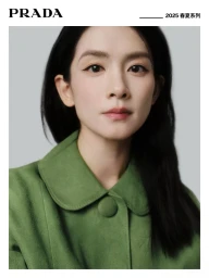 Portrait of Amy Chen Haoyu wearing a green collared coat against a plain grey studio background for Prada.