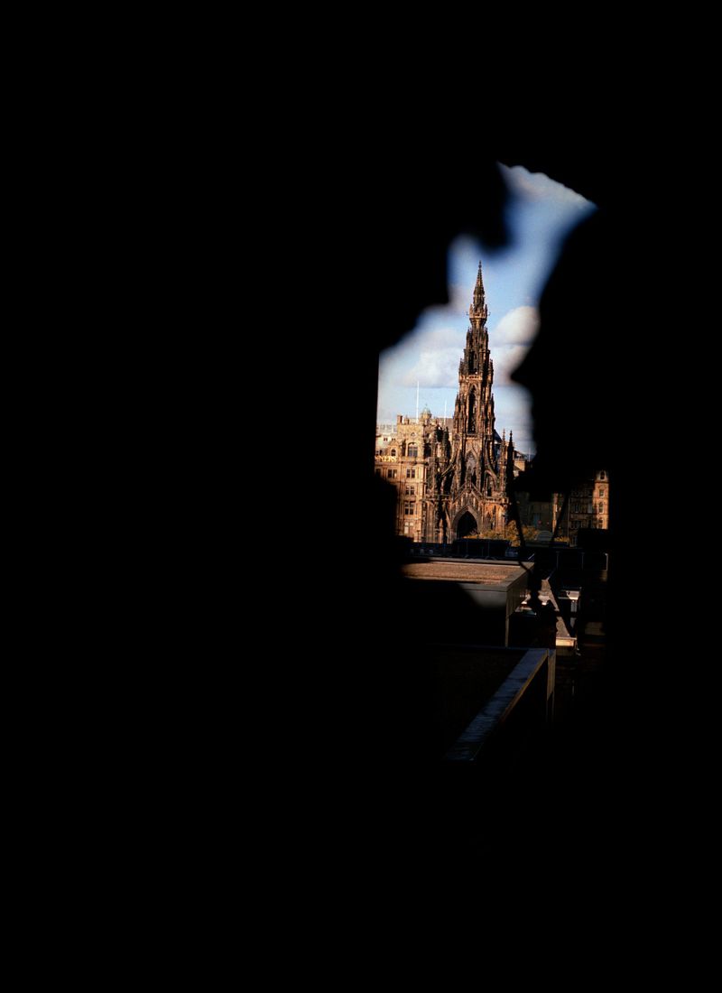 View of the Scott Monument, a Victorian Gothic monument in Edinburgh, Scotland, seen through an obscured foreground.