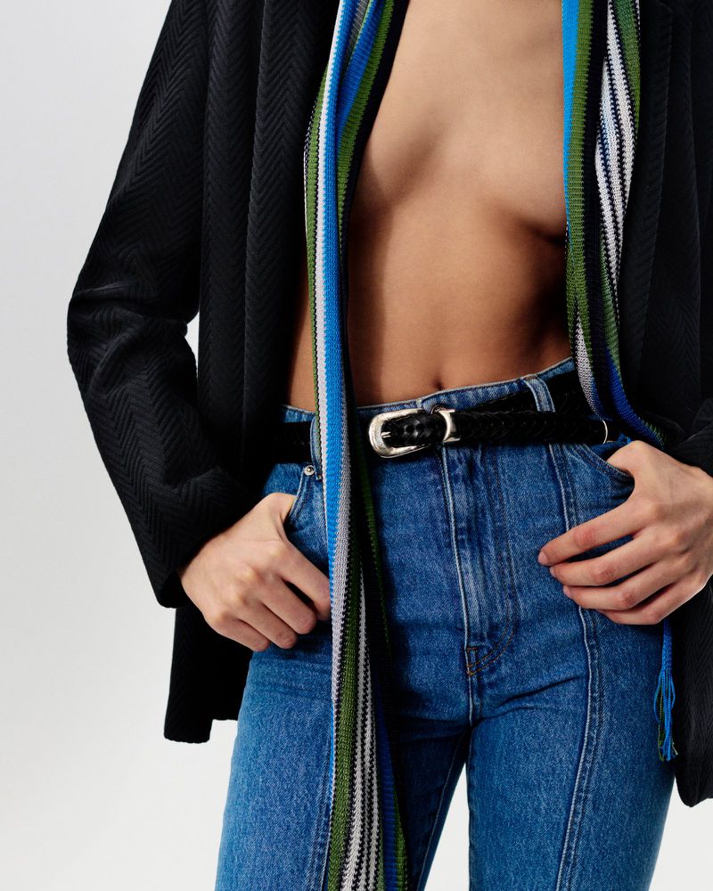 Model wearing a black blazer over high-waisted blue jeans and a striped scarf for Missoni Digital Spring Summer 2025