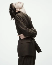 Model in brown blazer with head tilted back against white background for Armani Exchange campaign