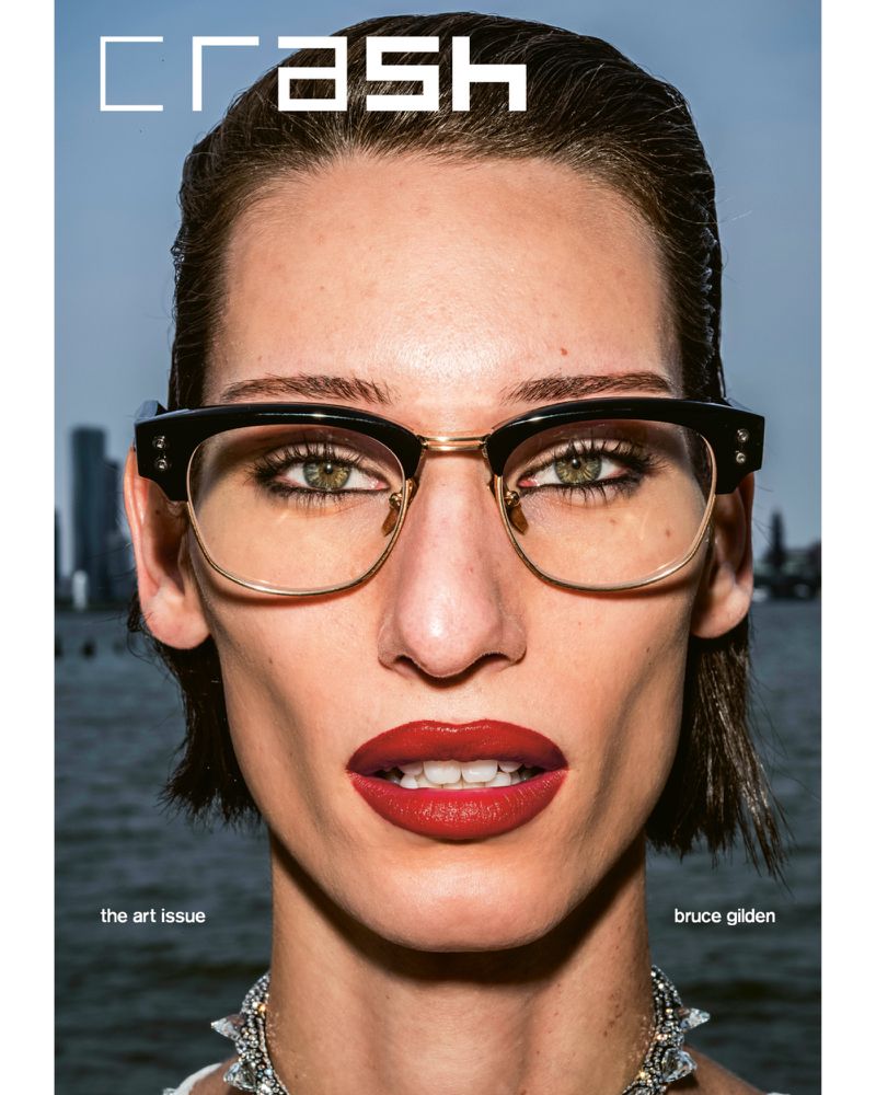 Close-up portrait of model Josephine Dupont wearing black and gold browline eyeglasses and red lipstick for Crash Magazine.