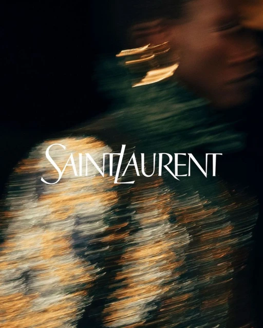 Fashion advertisement featuring a blurry portrait of a person with gold earrings and an abstract top, with Saint Laurent logo overlay.