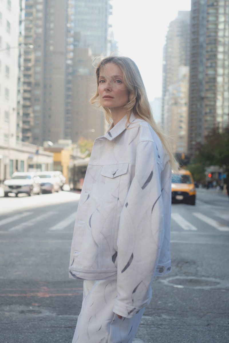 Model Eniko Mihalik wearing a patterned white jacket in a New York street scene
