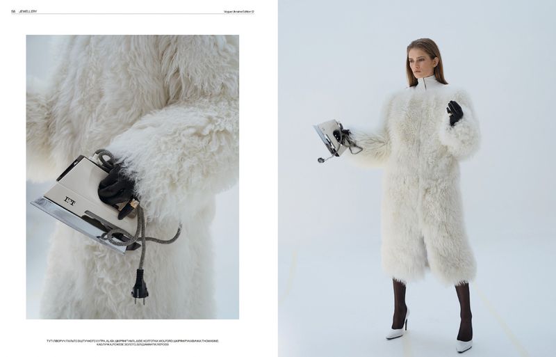 Fashion editorial shot of a woman in a faux fur coat holding a vintage iron in a brightly lit studio setting, style and design.