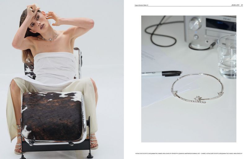 Fashion editorial shot: A female model sits on a fur-covered chair, complemented by a luxury bracelet showcased on a table nearby.