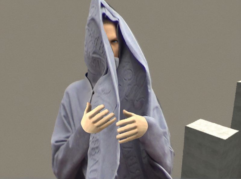 Person covered in patterned fabric with a hooded head covering. The scene features neutral tones and soft lighting in a studio.