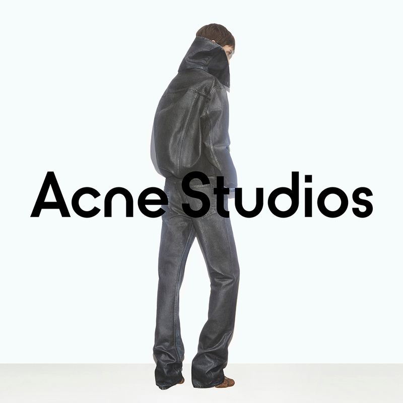 A person wears a dark leather jacket and pants in a fashion shot on a white background with the Acne Studios logo.