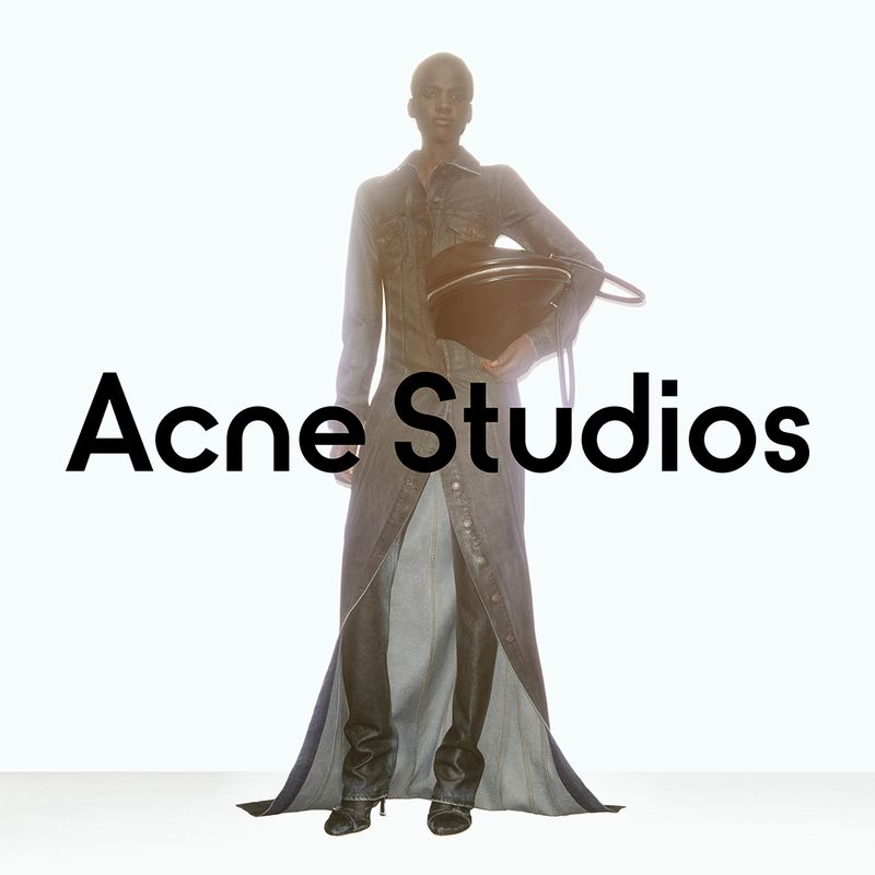 Fashion shot: a Black female model presents a denim outfit and black handbag against a bright background with the 'Acne Studios' logo.