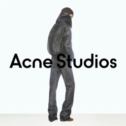 Model wearing a dark leather jacket and matching pants standing against a plain white background with bold brand text overlay