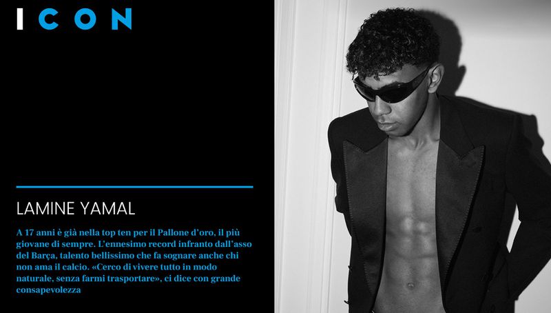 Black and white studio portrait of a shirtless young adult male with sunglasses, wearing a blazer; a fashion-forward portrait.