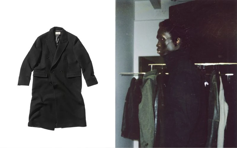 Black double-breasted overcoat on a white background next to an adult male with dark hair wearing black overcoat on rack.