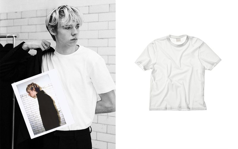 Blonde man in white t-shirt with photograph next to a white t-shirt on white background in an indoor environment.