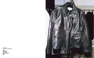 Distressed dark leather jacket hanging on a rack during a Zara Origins fitting session
