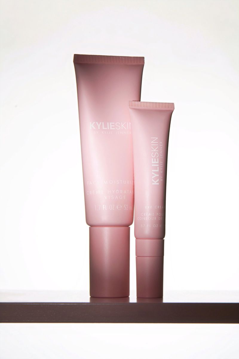 KylieSkin skincare product tubes, in graduated sizes, are presented in a studio setting, showcasing beauty and skincare photography.