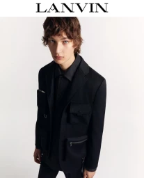 Model wearing a black multi-pocket blazer against a plain white background for Lanvin Winter 2024